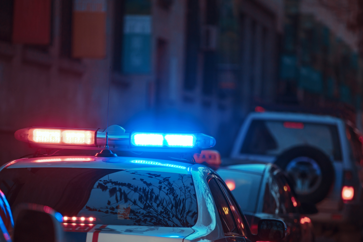 Spokane police officers arresting a driver after a Spokane motorcycle car accident fatality